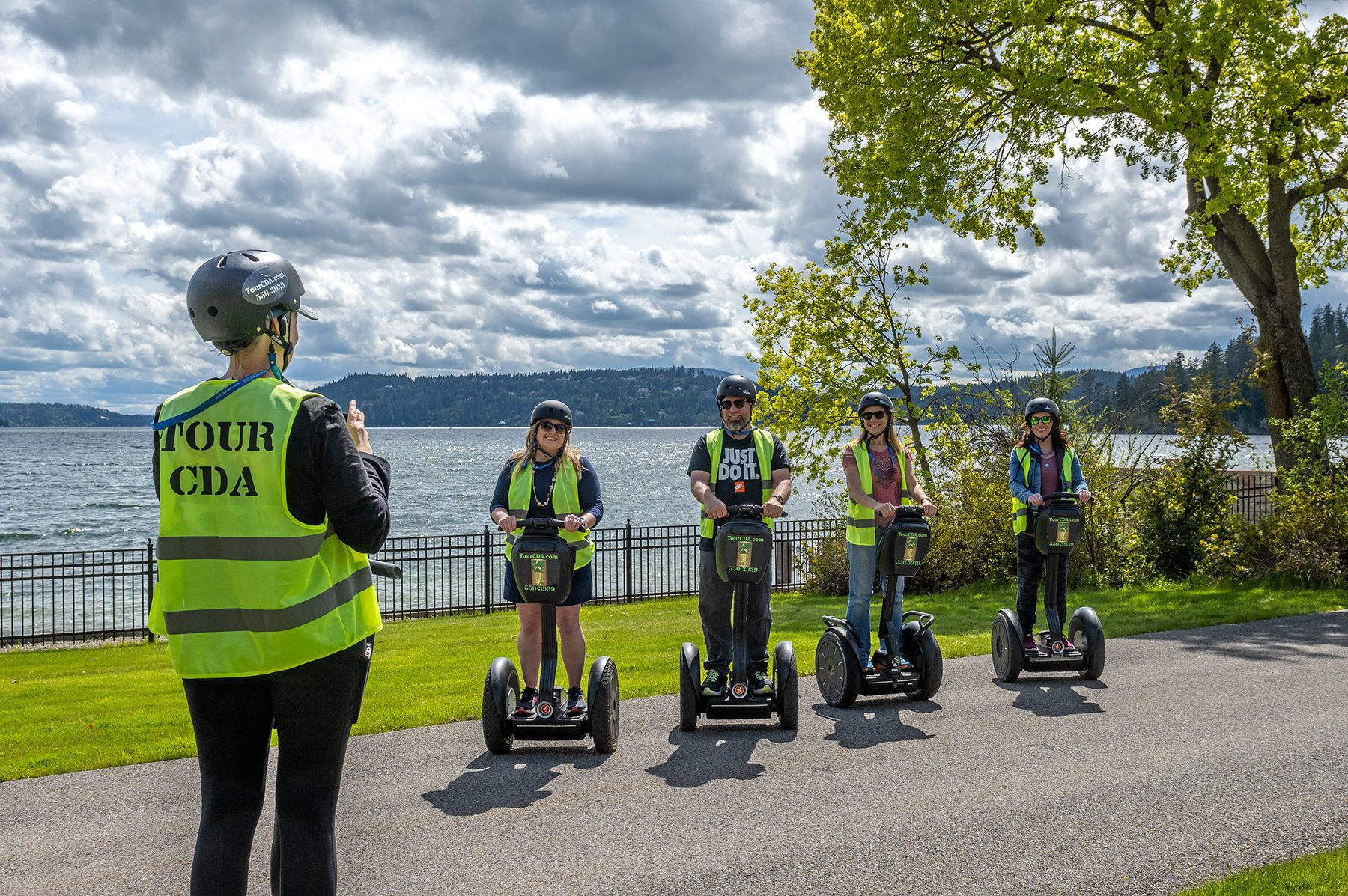 Tour CDA Segway guide with riders at Lake Coeur d' Alene — Jewett House stop