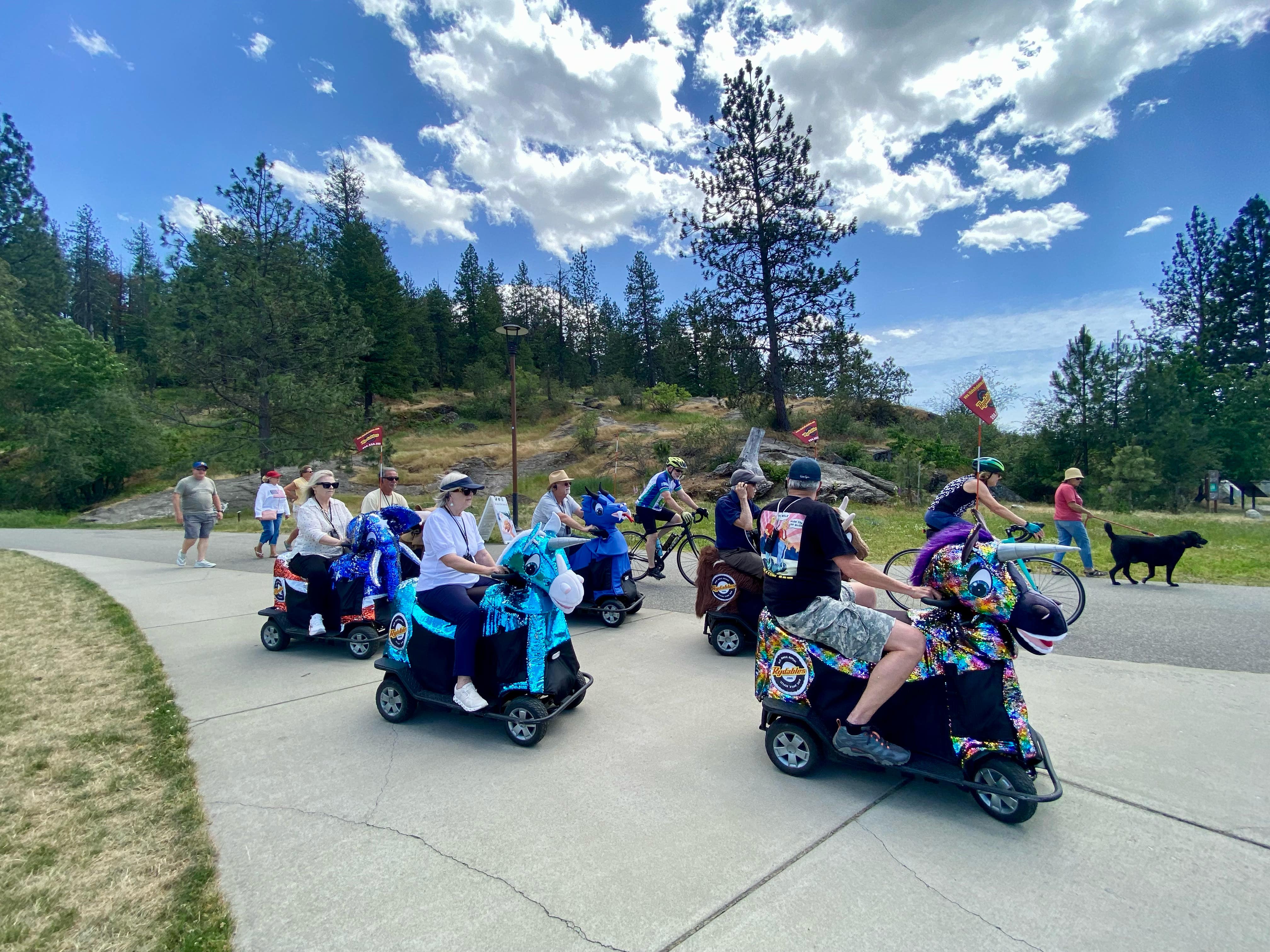 Tubbs Hill natural area in Coeur d'Alene Idaho with Tour CDA Rydables animal scooters on the Lake Coeur d'Alene shoreline trail